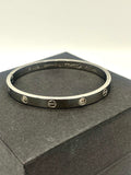 Stylish gold bangle bracelet with artificial diamond details, offering a luxury-inspired design.