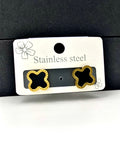 Elegant clover-shaped earrings with a black center and gold detailing, perfect for modern fashion.