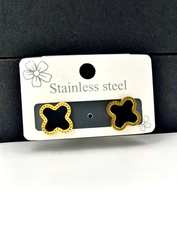 Elegant clover-shaped earrings with a black center and gold detailing, perfect for modern fashion.