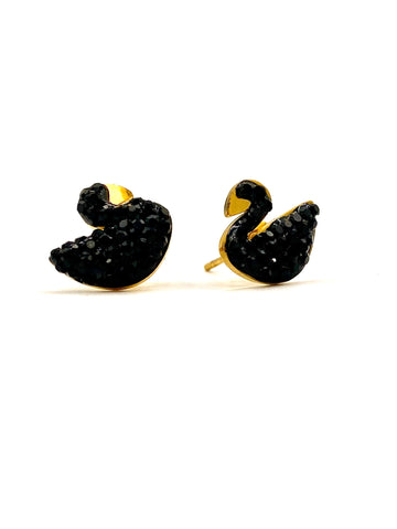 Close-up of black crystal swan-shaped stud earrings with gold-plated frame.