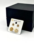 Close-up of two pairs of gold stud earrings, one with a crystal accent and the other with a sleek gold design.