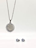 Elegant sunflower pendant necklace and crystal stud earrings set in silver.