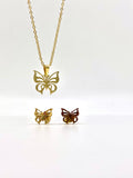 Close-up of a gold necklace with a butterfly pendant and matching stud earrings.
