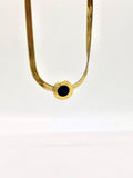 Elegant gold necklace with black center stone, perfect for modern fashion.