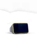 Close-up of a black and gold stainless steel square ring for men.